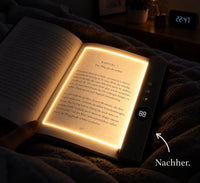 Kyrena Leselicht in Schwarz auf aufgeschlagenem Buch im Bett